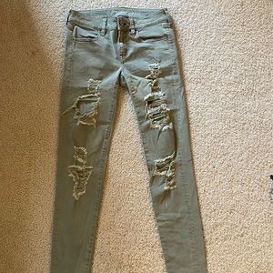Olive green ripped jeans with stretch